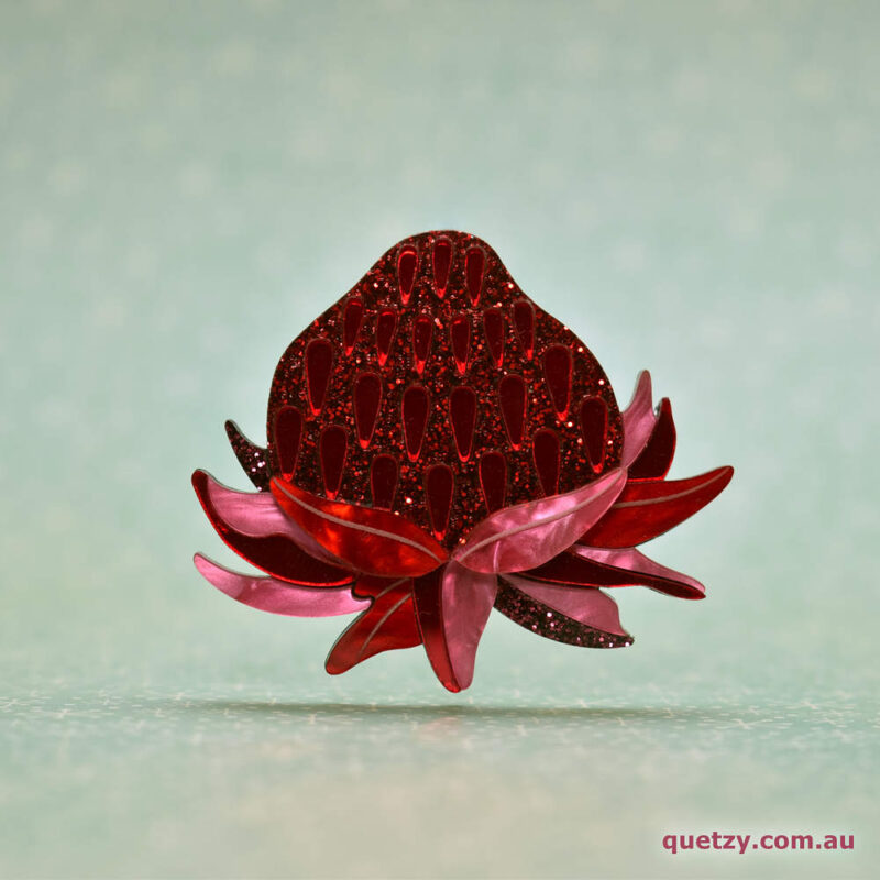 Stylised Mainland Waratah acrylic brooch in glittery colours. Designed and handmade by Quetzy.