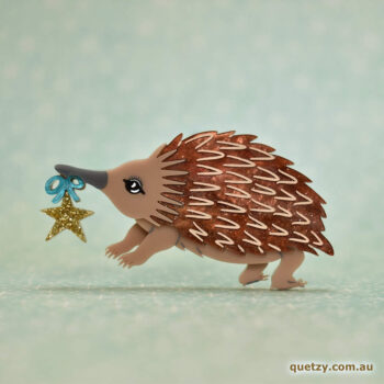 An Echidna holding a gold star and blue bow to celebrate the good times. Australian Monotreme Brooch