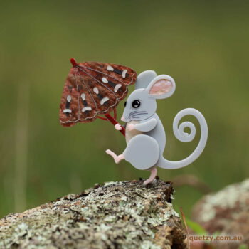 An acrylic brooch of a parading Mountain Pygmy Possum shaded by a Bogong Moth umbrella