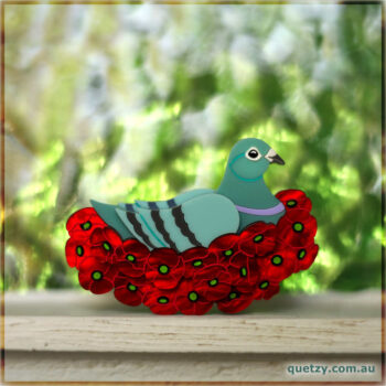 Pigeon sitting in a nest constructed of rememberance day poppy flowers. Acrylic brooch designed and handmade by Quetzy