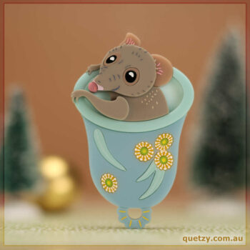 An Australian Honey Possum in an upturned bell decorated with eucalypt flowers and gum leaves. Acrylic brooch designed and handmade by Quetzy