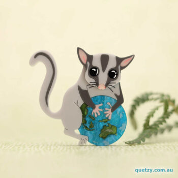Lottie the Leadbeater's Possum holding our fragile planet earth. She is our new year-round planet protector. Acrylic brooch designed and handmade by Quetzy.