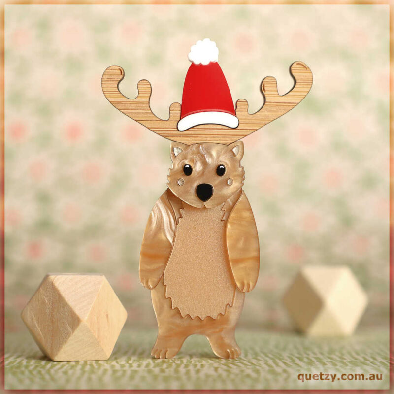 Wonderful Wombat acrylic brooch standing on two feet with her stunning Christmas Hat. Designed and created by Quetzy.