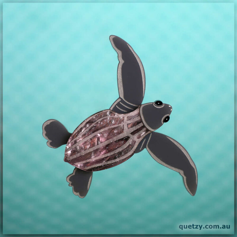 Tiny Leatherback Turtle Hatchling emerging from the nest. This acrylic brooch three-set designed and created by Quetzy.