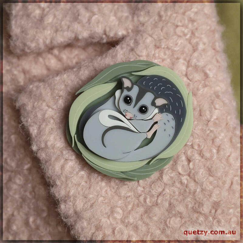 What could possibly be more adorable than a Sugar Glider snuggled up in it's nest? This brooch is presented in complimentary tones and delicate colour layering. Designed and hand crafted by Quetzy.